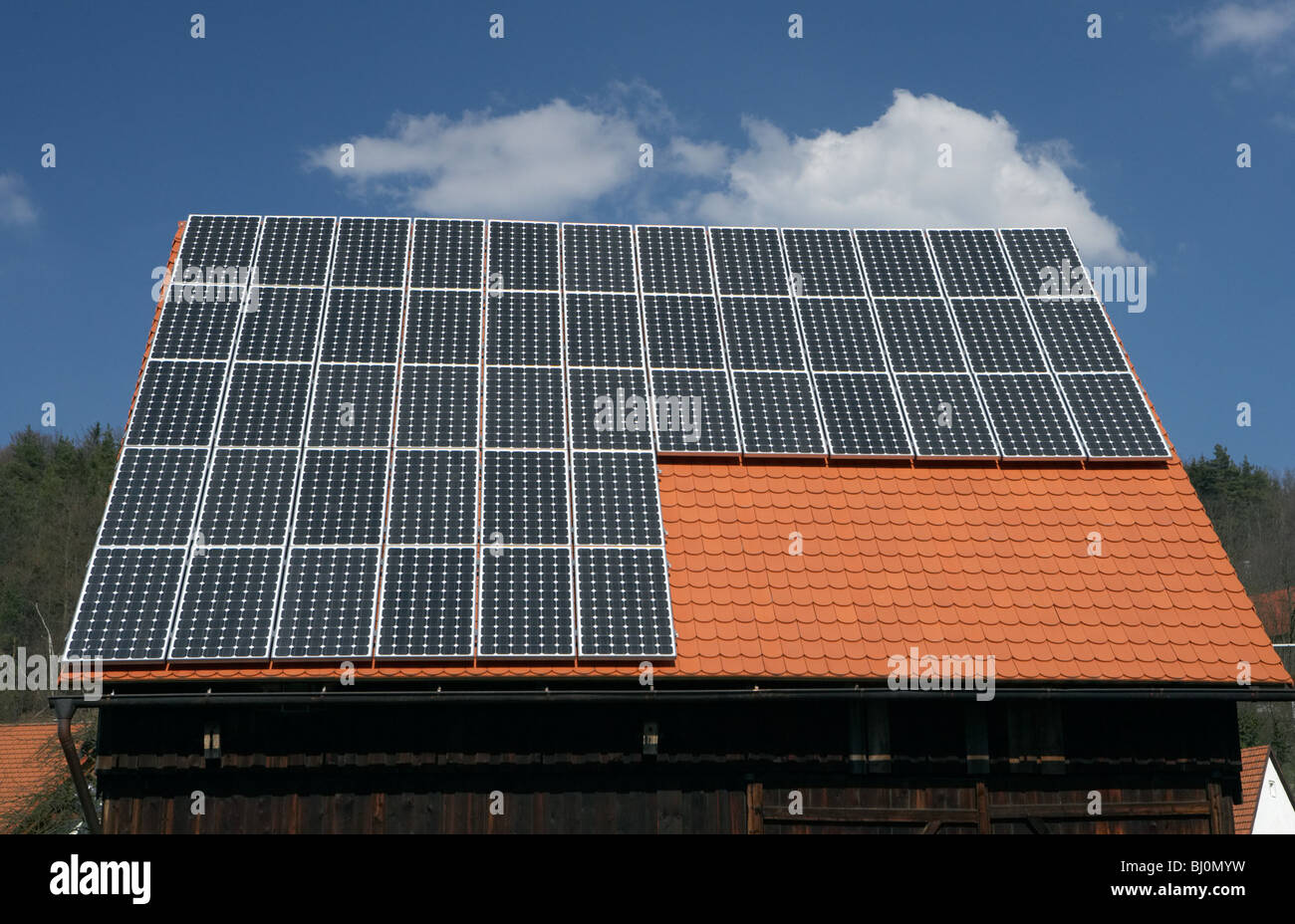 Solar cells on the roof of a farmstead, Goldkronach, Germany Stock Photo