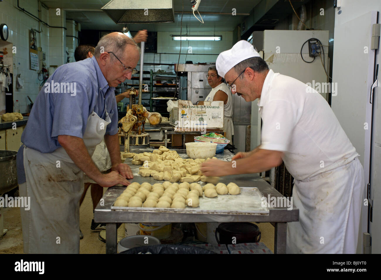 Baker forming dough for buns, Valldemossa, Majorca, Spain Stock Photo