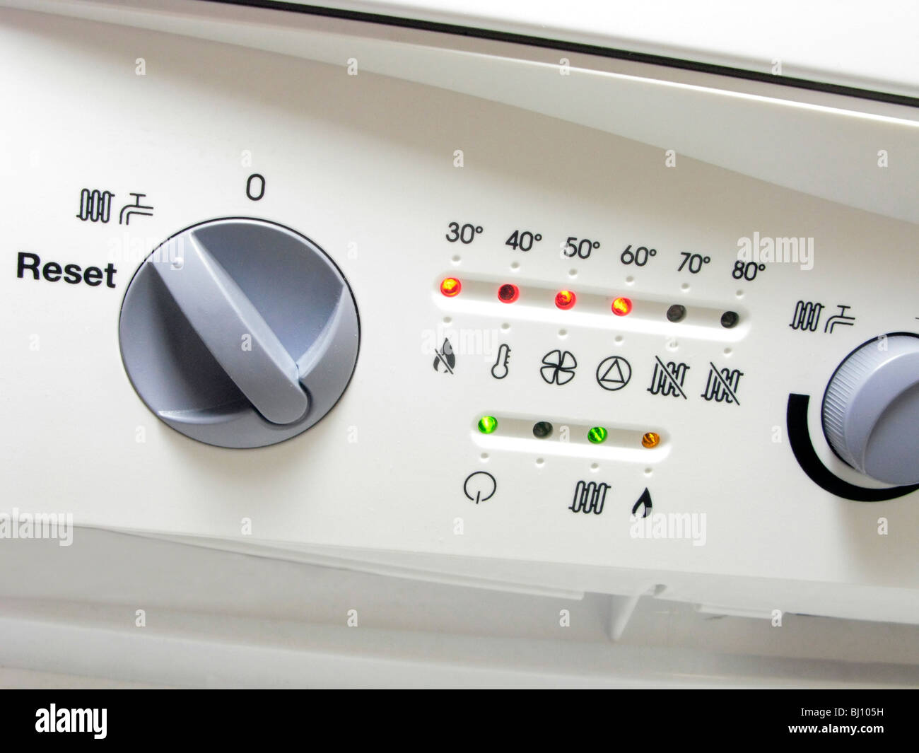 facia panel on an A rated condensing boiler showing switches & temperature gauge Stock Photo