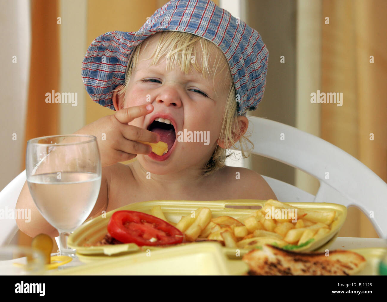 Child eating French fries Stock Photo