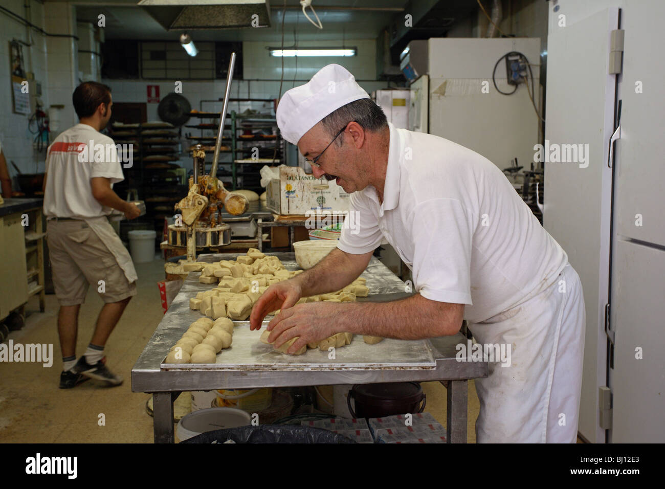 Baker forming dough for buns, Valldemossa, Majorca, Spain Stock Photo