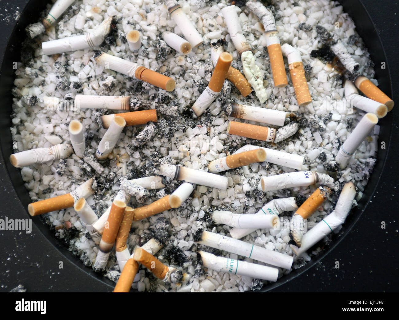 An ash tray full of cigarette stubs Stock Photo
