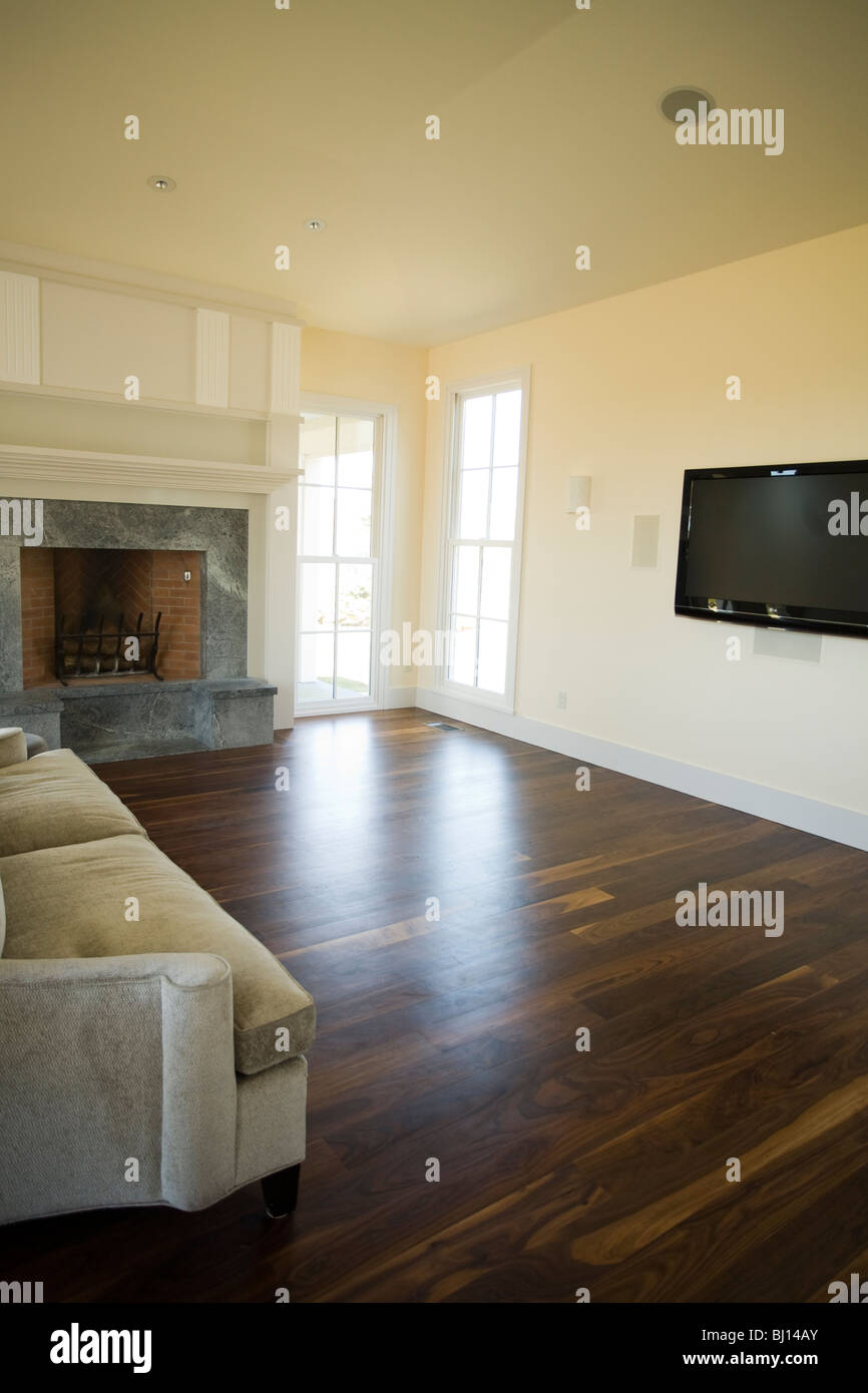 Large new New England living room with huge television and a fireplace. Stock Photo