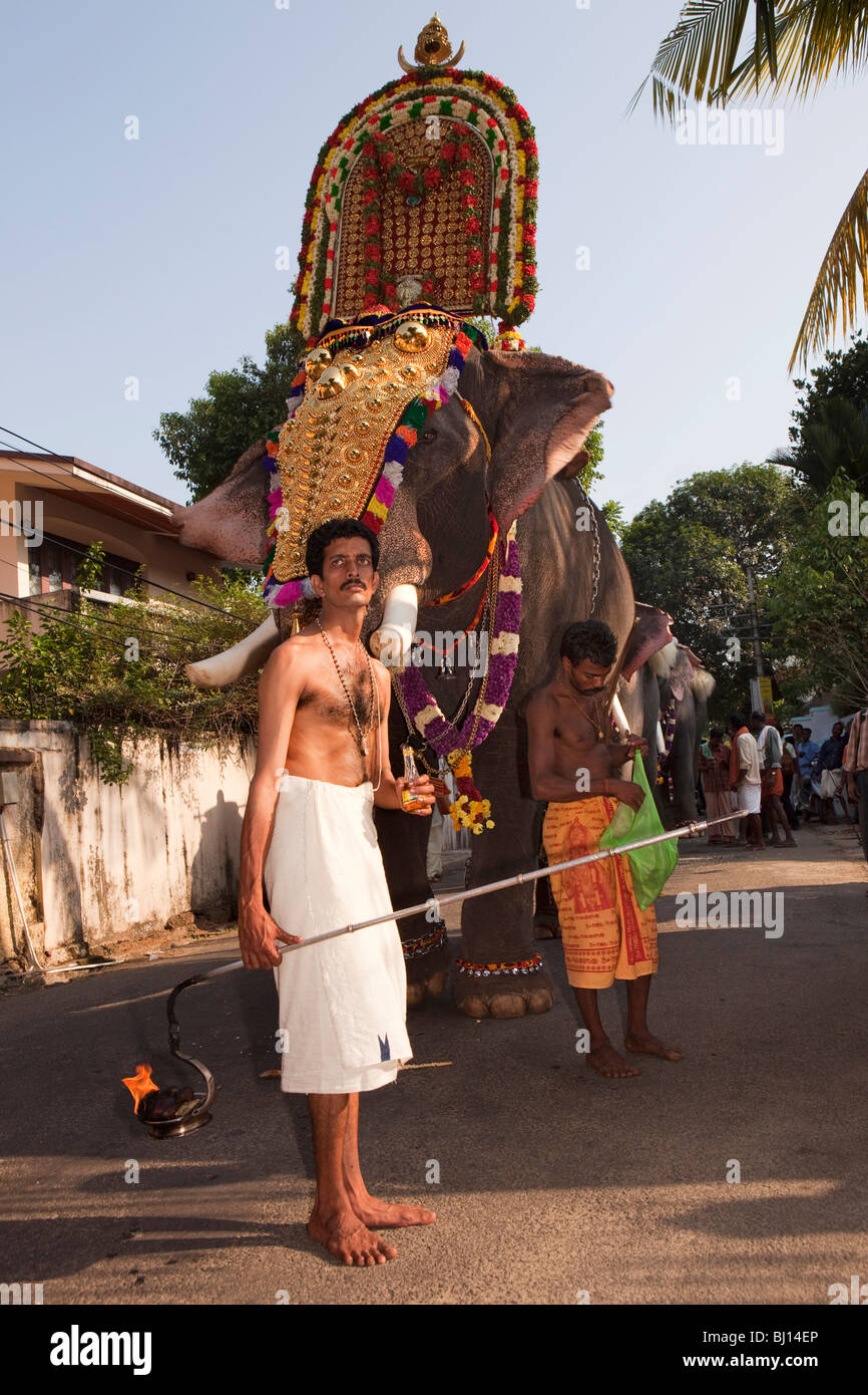 India, Kerala, Kochi, Ernakulam Uthsavom festival, Parayeduppu elephant procession priest carrying sacred fire for puja Stock Photo