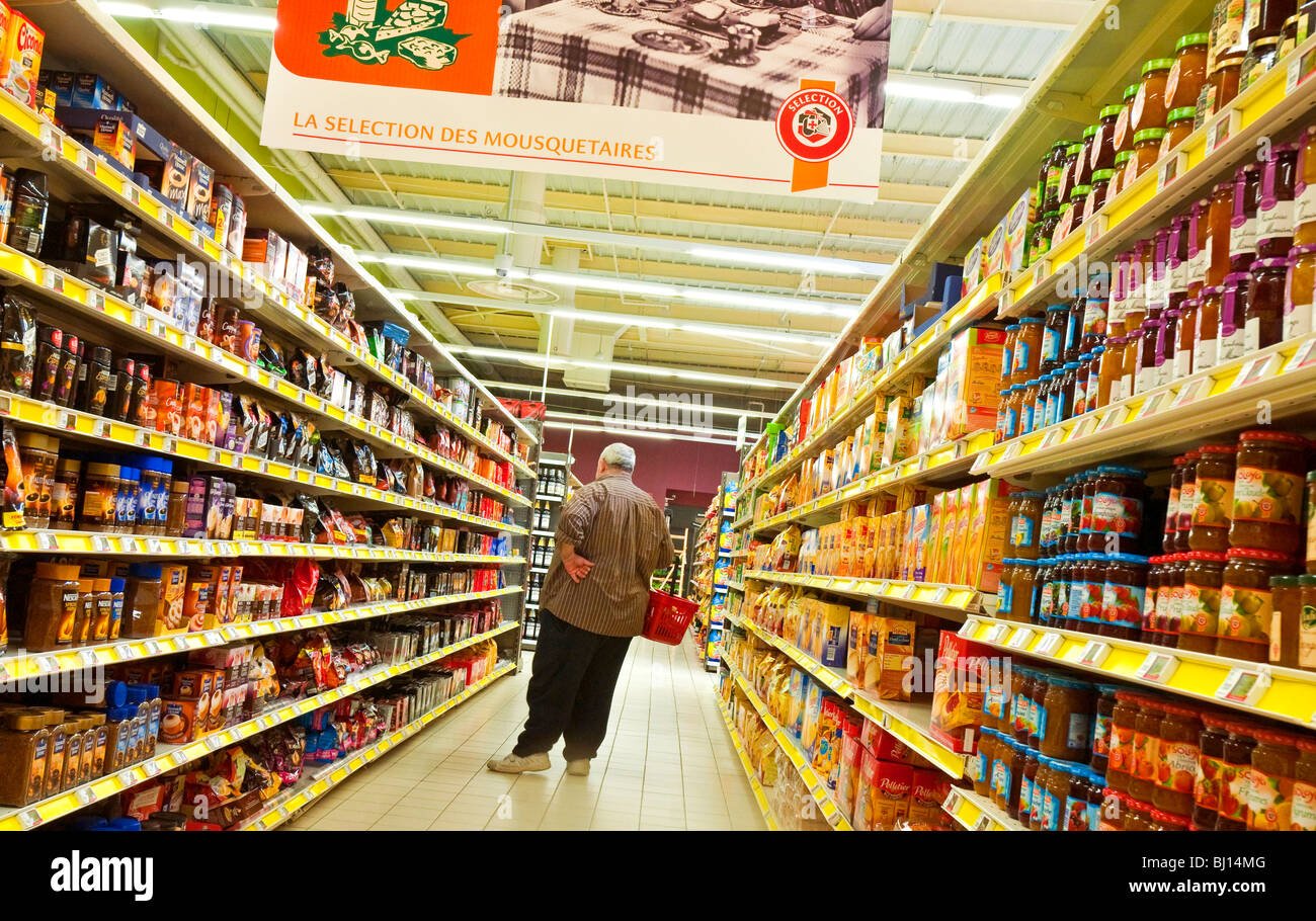 Coffee, biscuits and jam on supermarket shelves - France. Stock Photo