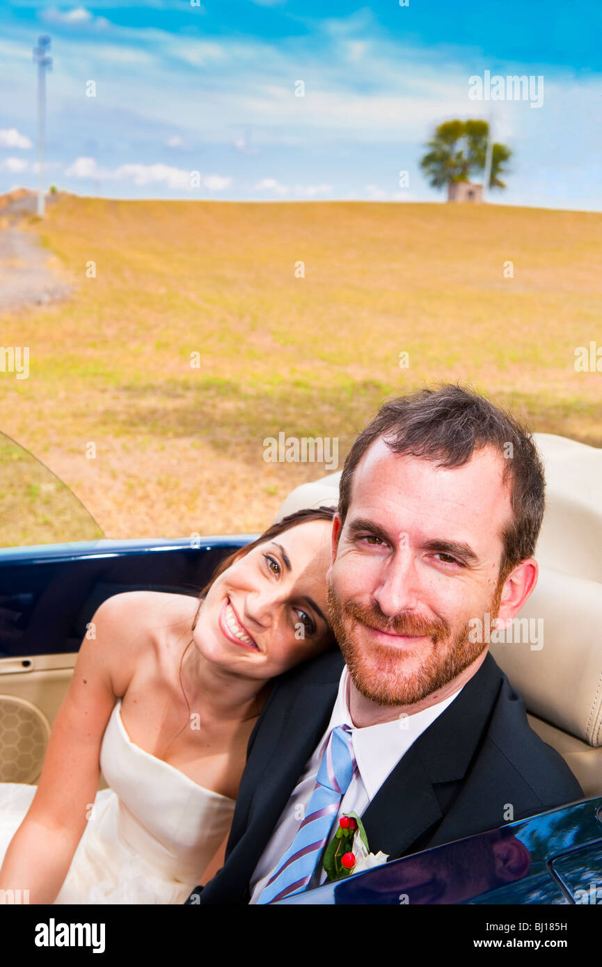 Bride and groom in a wedding convertible car Stock Photo - Alamy