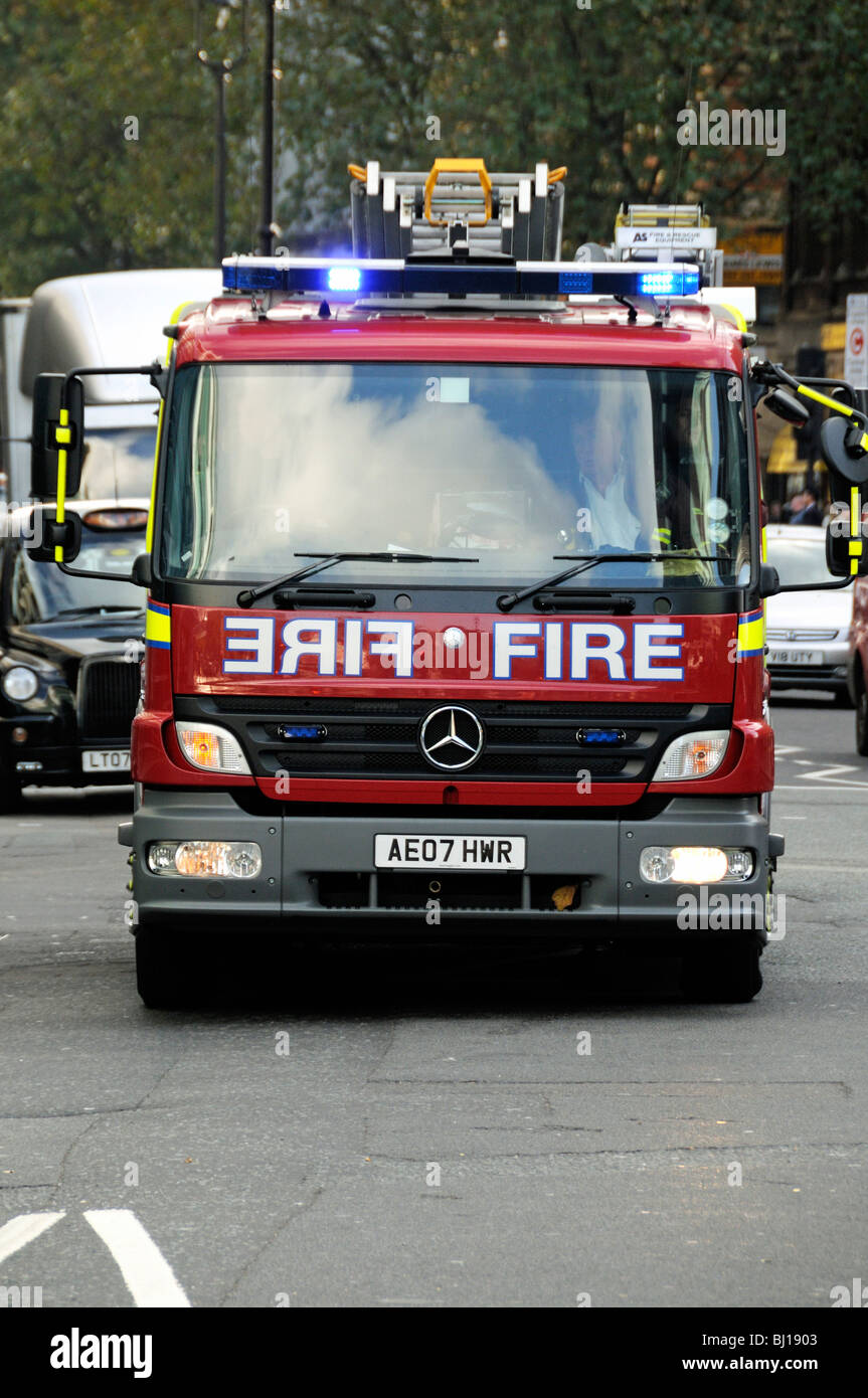 Fire Engine with blue lights flashing on emergency call London England UK Stock Photo