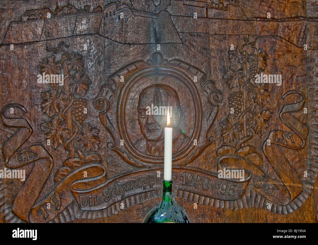 Candle in front of huge oak barrel in the wine cellar of The Residenz