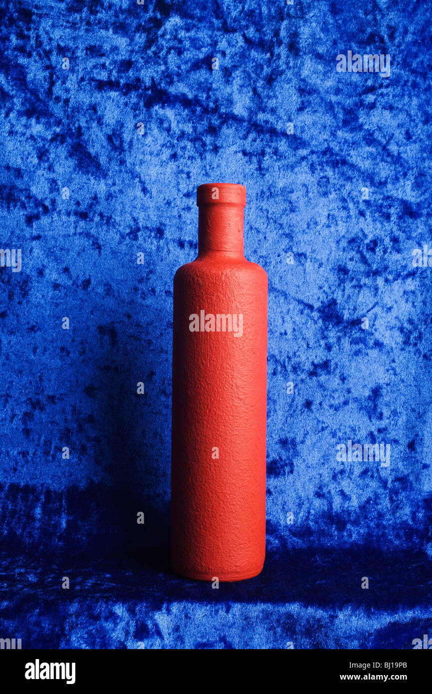 A red bottle on a blue background Stock Photo Alamy