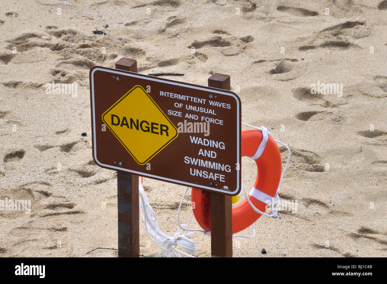 High Waves:High wave warning sign on a California Beach-'intermittent waves of unusual size, wading and swimming unsafe' Stock Photo