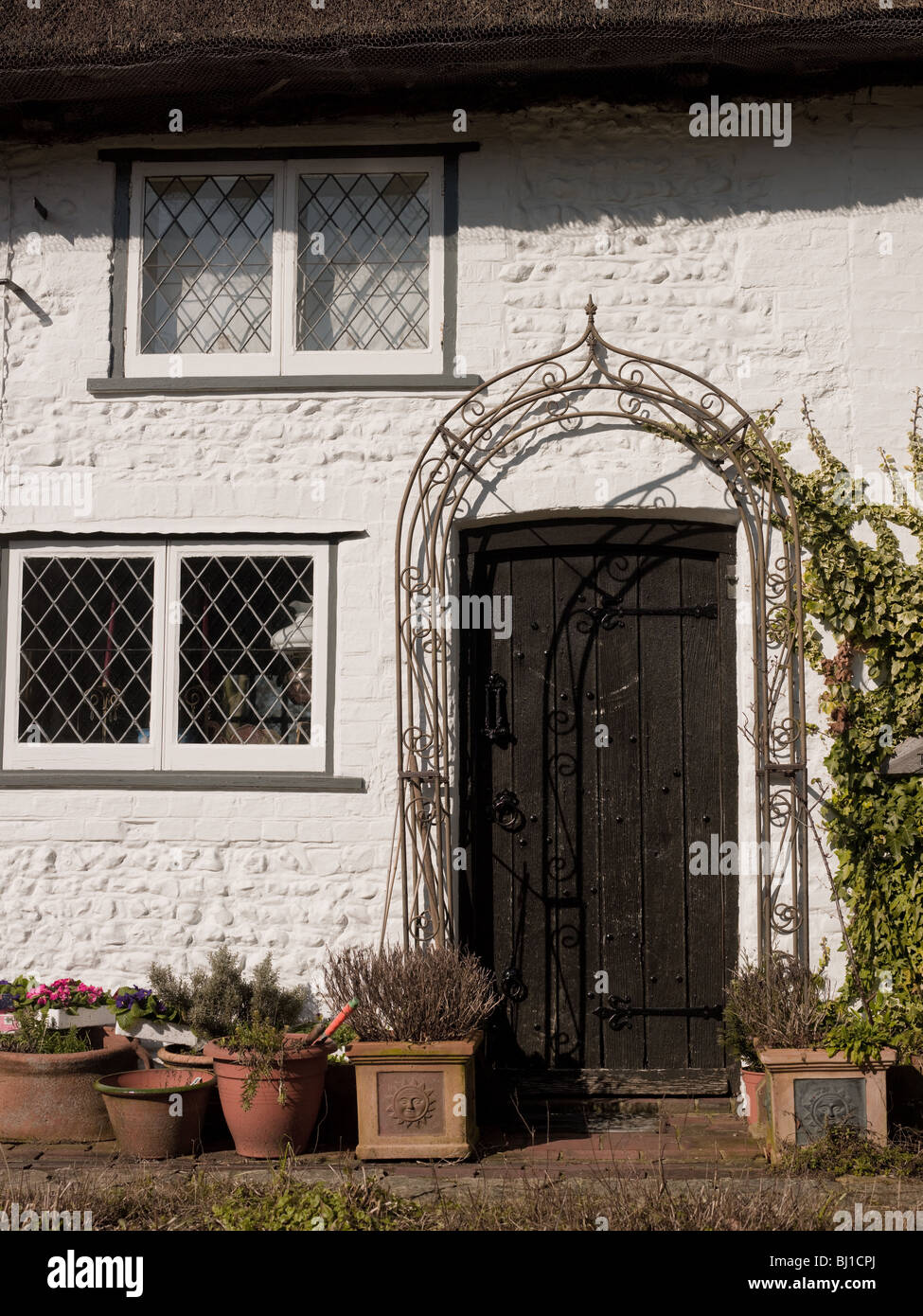 Facade of an old cottage with oak front door. Stock Photo