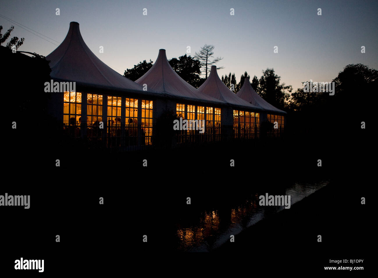 Night Silhouette Of Wedding Reception Party In Gazebo Tents Stock