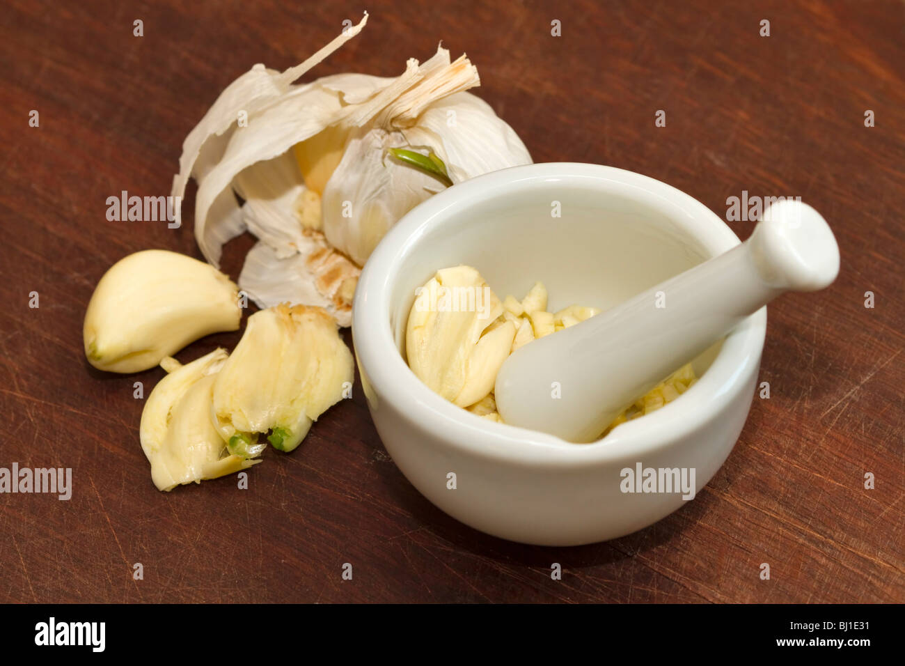 Garlic ready for mashing in a mortar and pestle Stock Photo Alamy