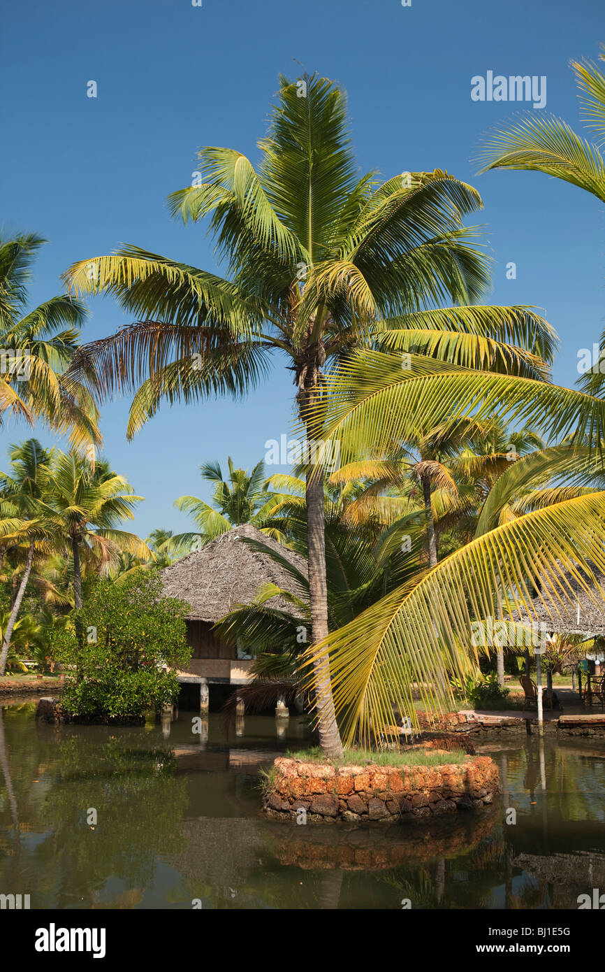 India, Kerala, Vypeen Island, Cherai Beach Resort, luxury accommodation bungalows amongst palm trees, Stock Photo