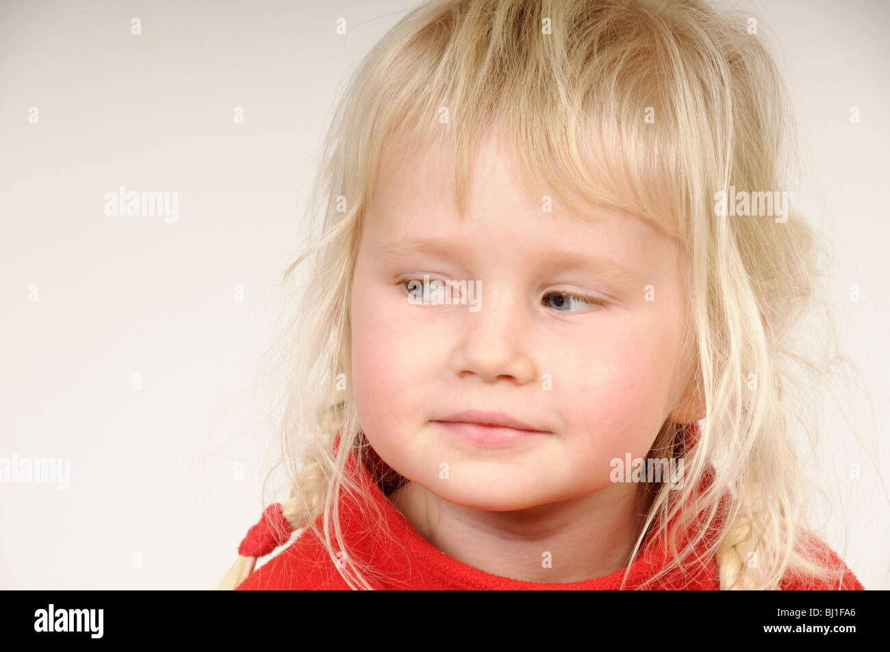 Stock photo of a blond haired four year old child looking to her right. Stock Photo