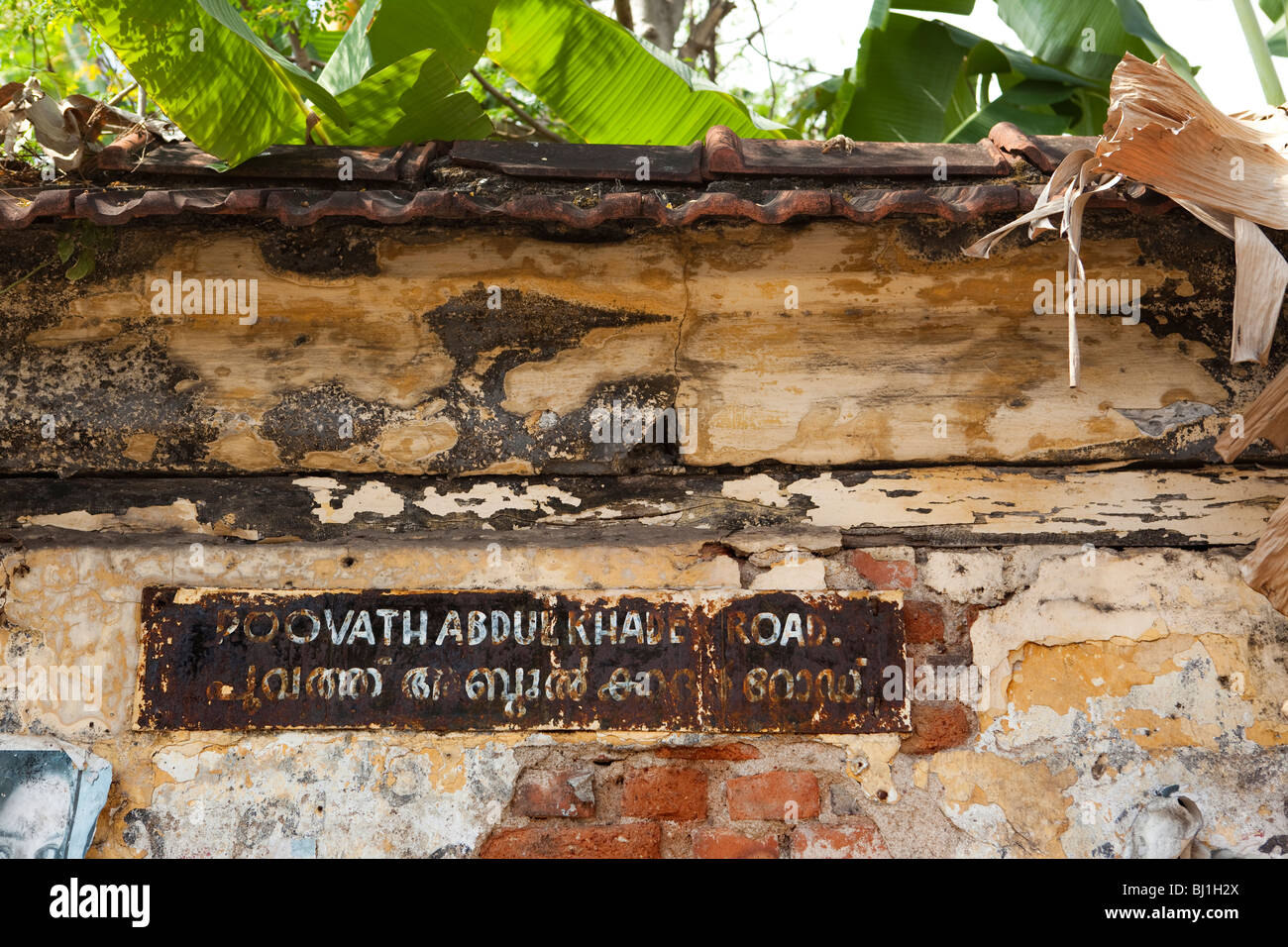 India, Kerala, Kochi, Fort Cochin, Poovath Abdul Khader Road name sign in English and Malayallam languages Stock Photo