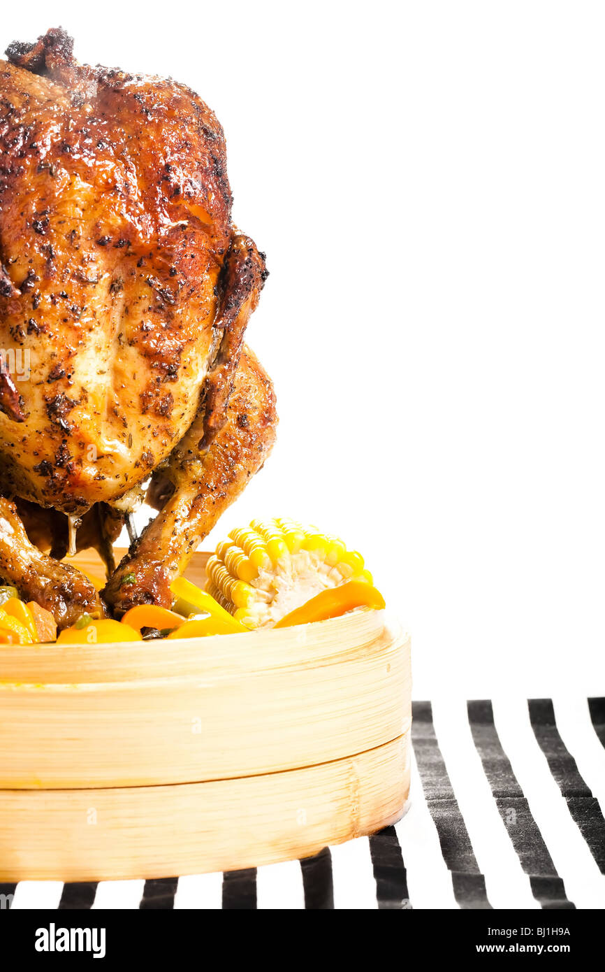 Upright grilled chicken in a bamboo steamer filled with fresh veg Stock