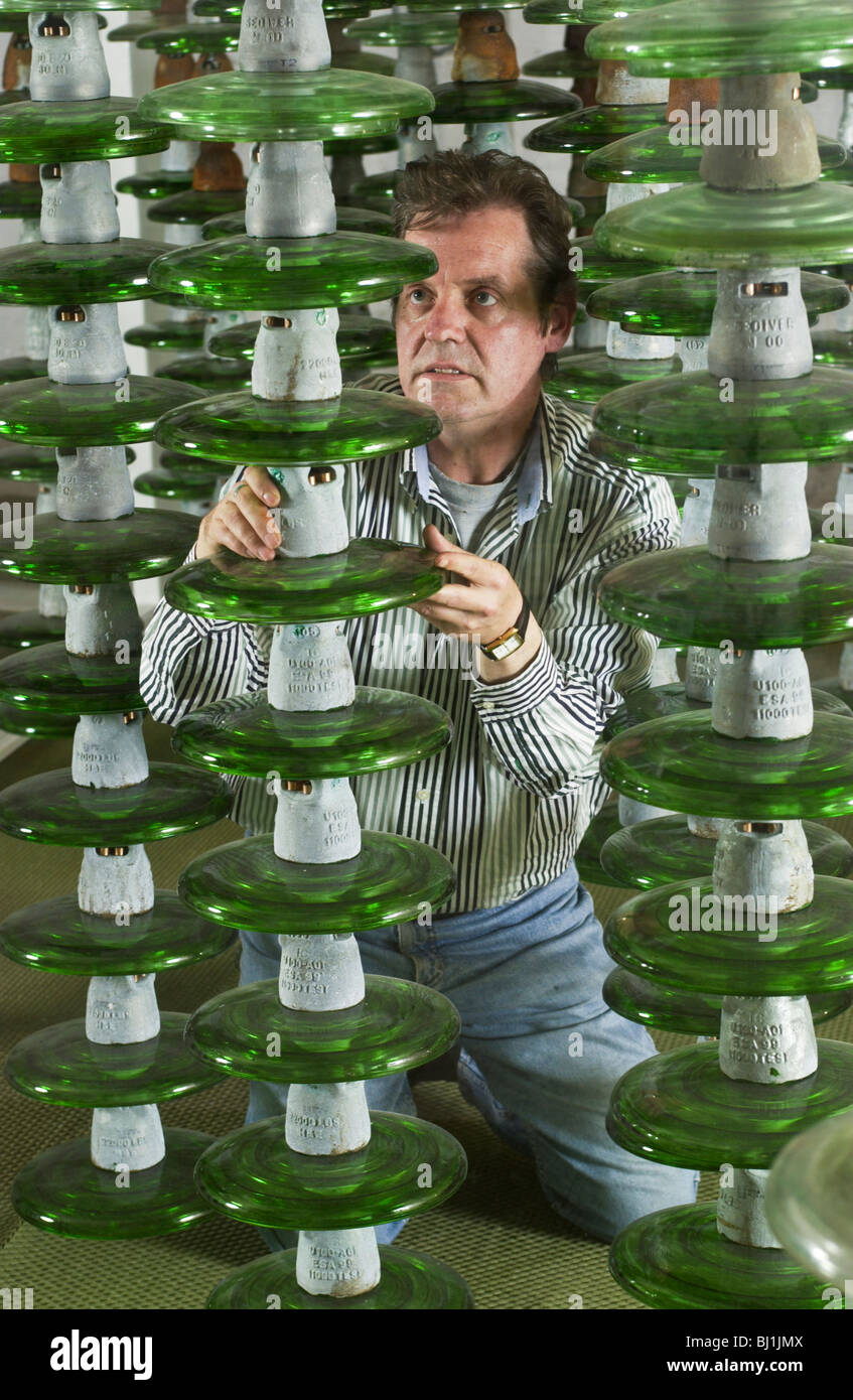 Sculptor, Andrew Cooper with his sculpture 'EURHYTHMY' made from recycled glass insulators off electricity pylons in his studio Stock Photo