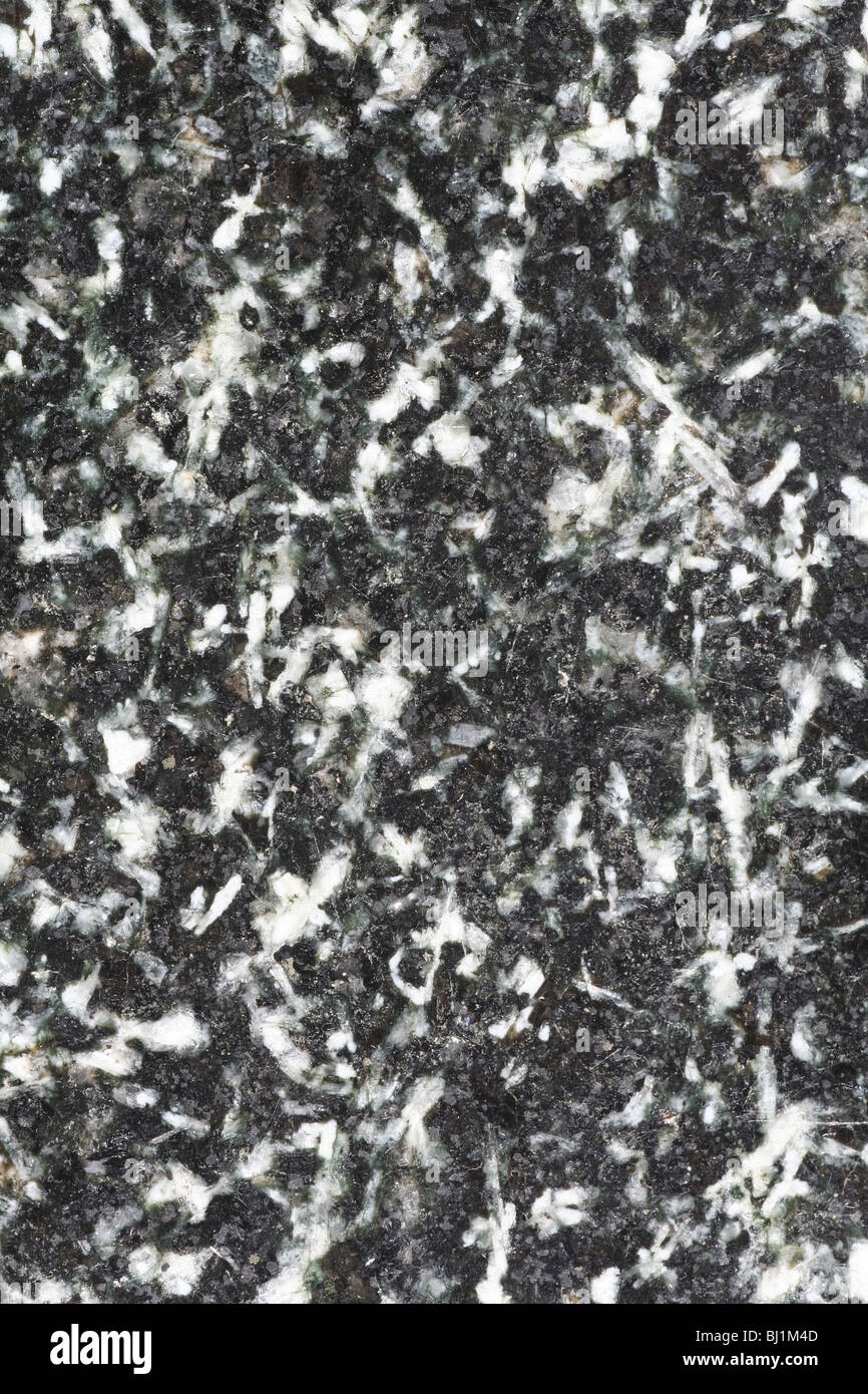 Polished granite surface with black, gray and white elements. Stock Photo