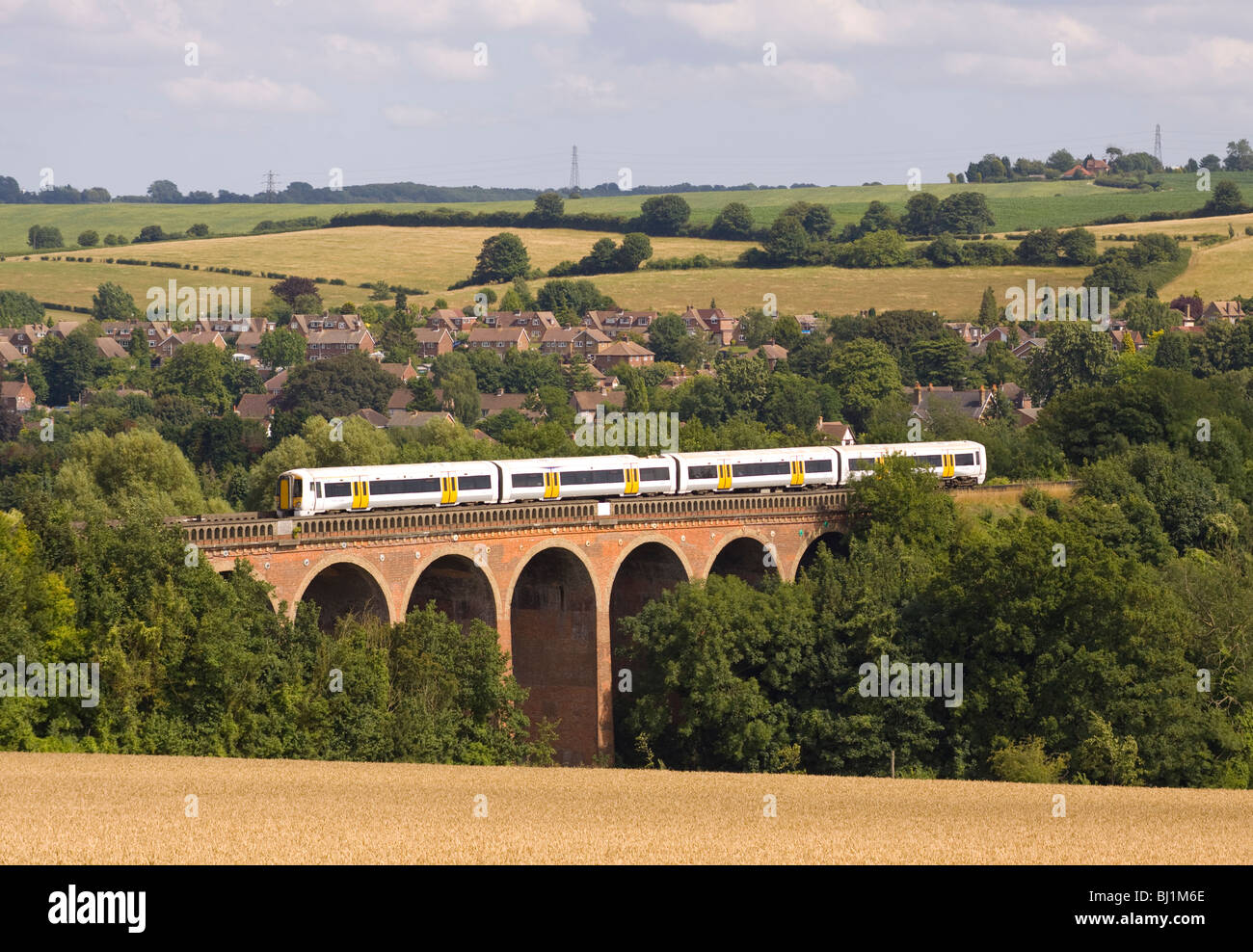 Modern passenger train crossing over Eynsford Viaduct in Kent England Stock Photo