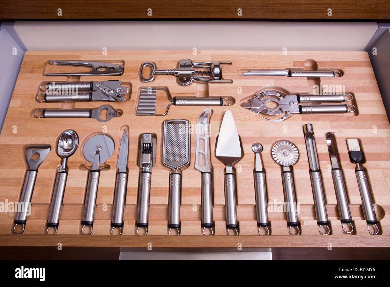 Various kitchen tools in organized kitchen drawer Stock Photo