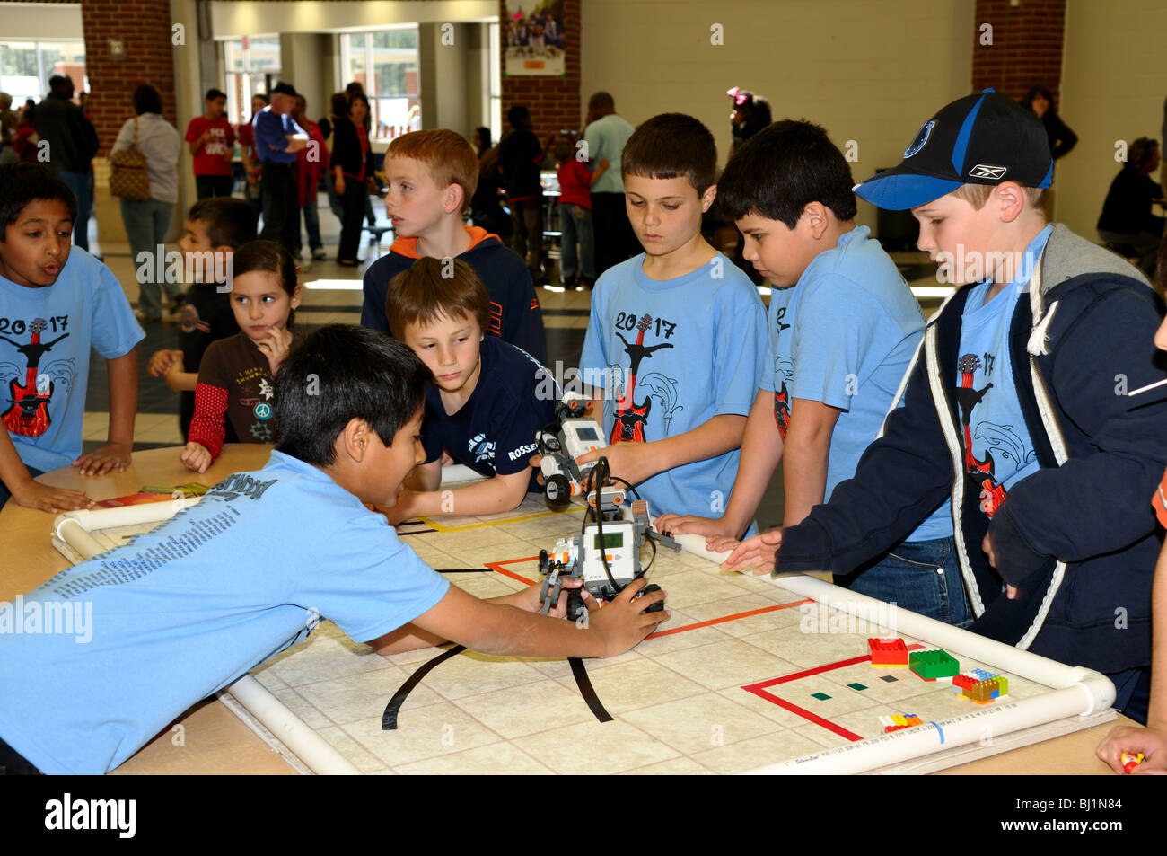 School kids testing a Lego robot during a science fair . Stock Photo