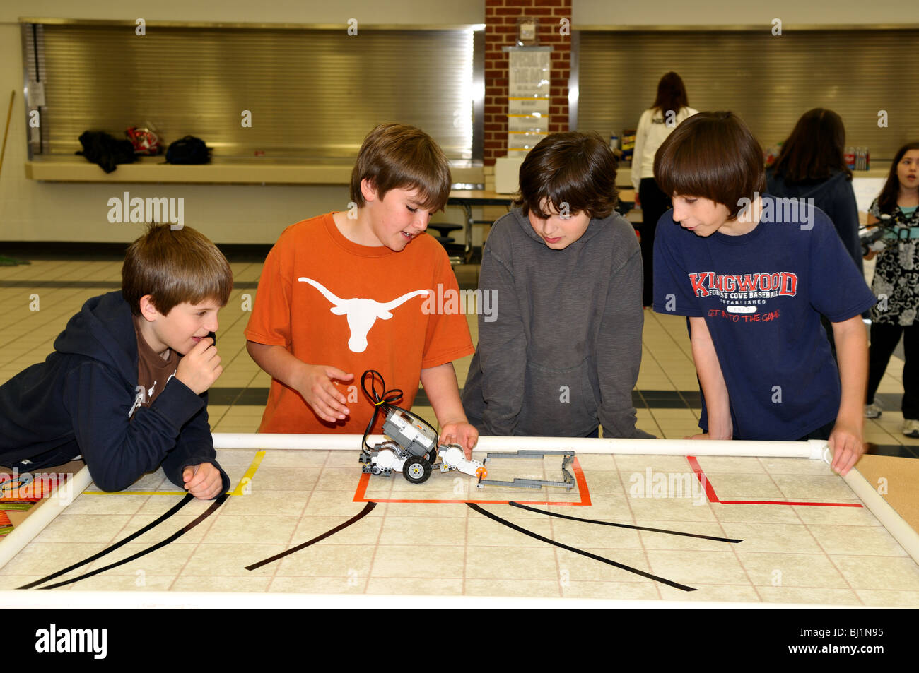 School kids testing a Lego robot during a science fair. Stock Photo