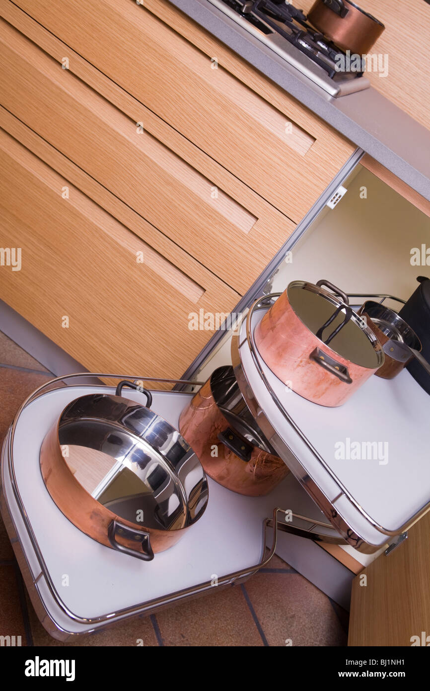 Details of a modern luxury kitchen Italian production: extensible shelves for pots and implements Stock Photo