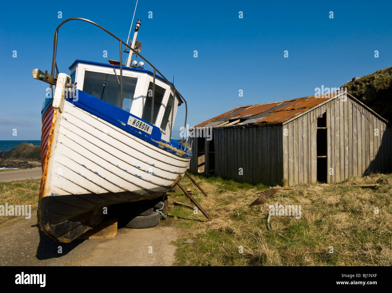 Beached Fishing Boat and Old Wooden Shed, Banff Stock Photo