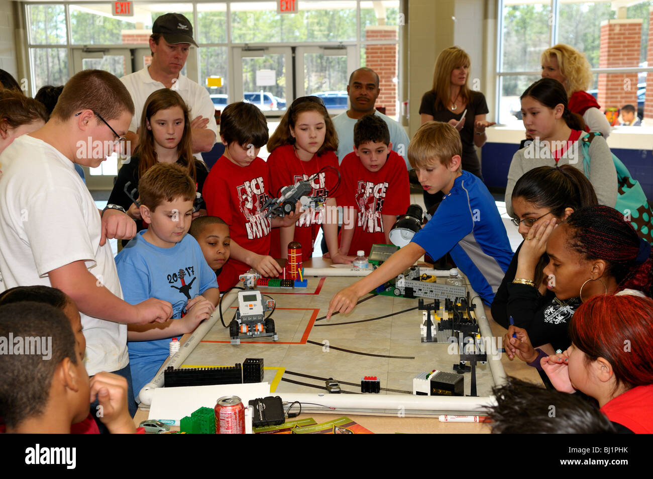 School kids building and testing a Lego robot at a science fair. USA. Stock Photo