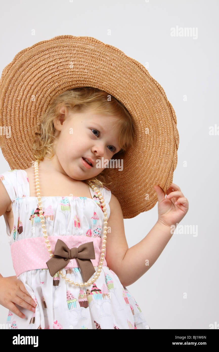 A three year old blond little girl wearing a straw hat Stock Photo - Alamy