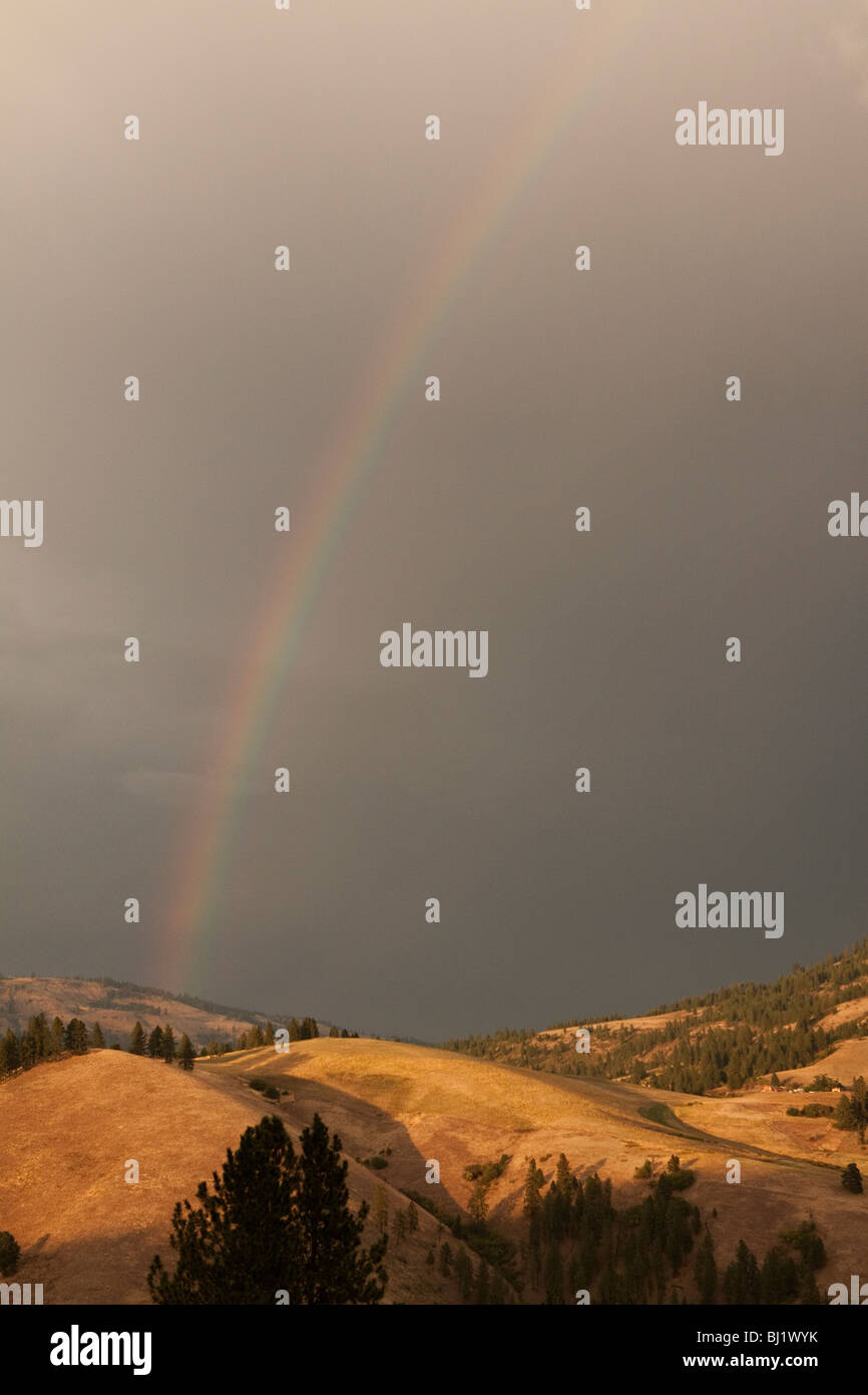 Rainbow over ridge in Idaho Stock Photo Alamy