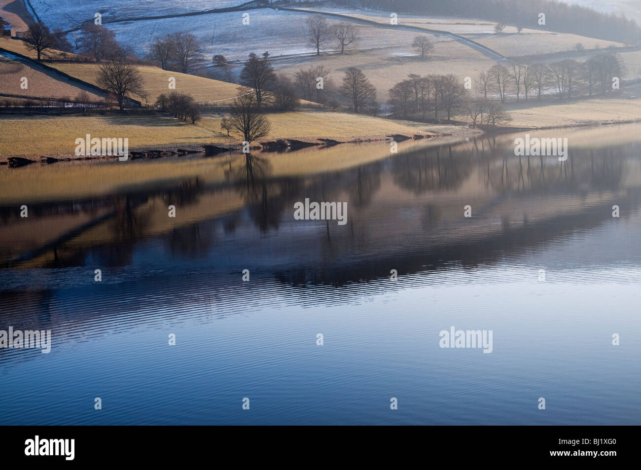 Reflections in Ladybower Reservoir on a winter morning Stock Photo