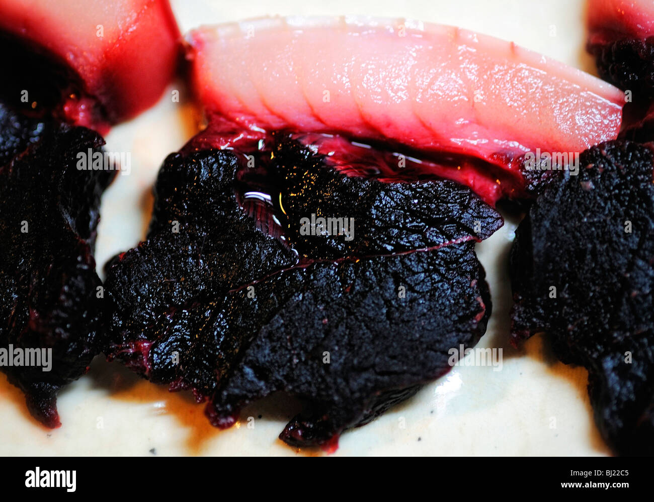 Slices of dolphin meat are arranged on a plate in Japan. Stock Photo