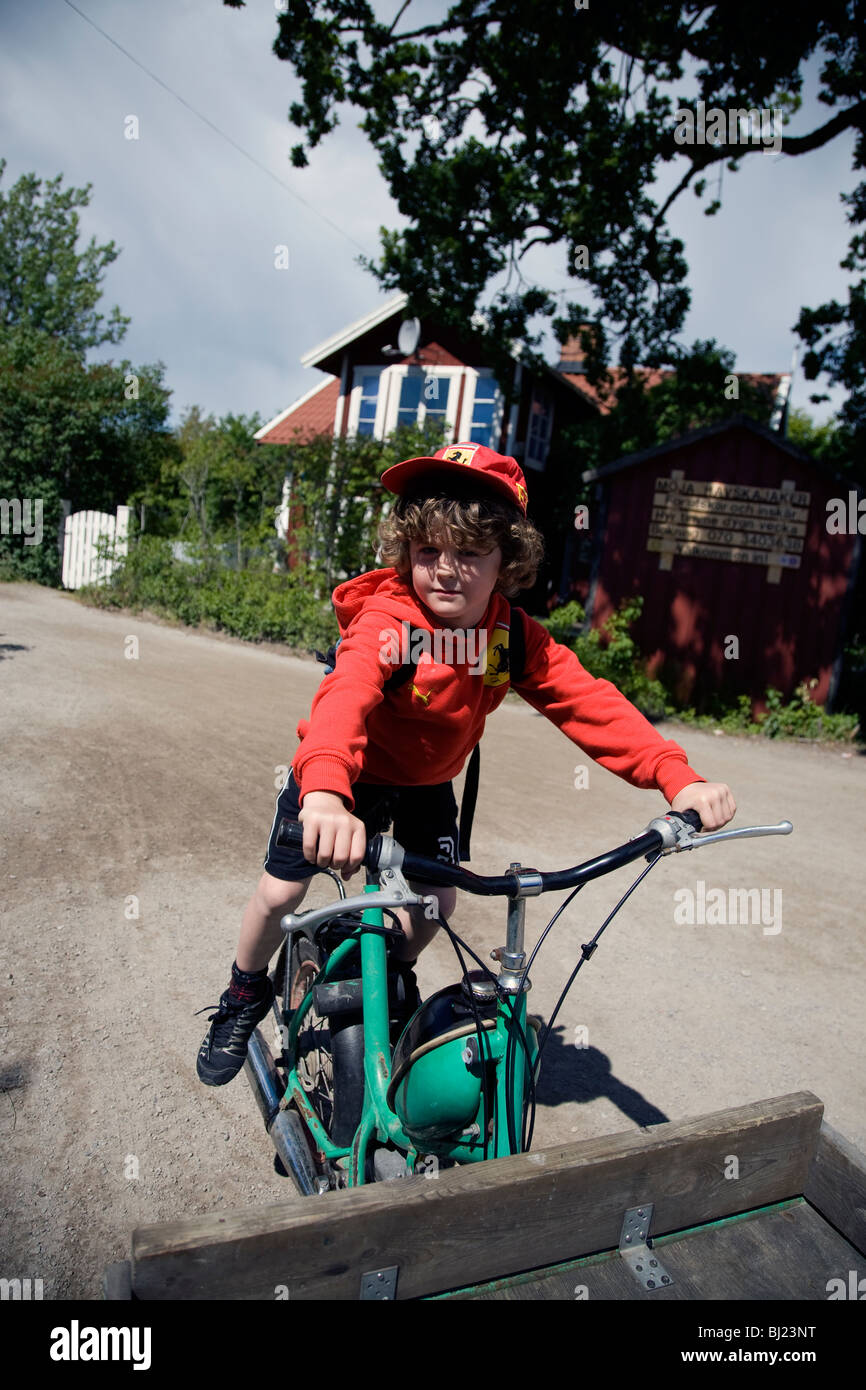 A boy trying to drive a moped Stock Photo Alamy