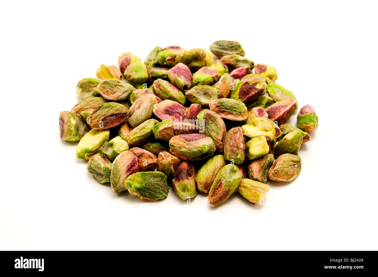 Unshelled roasted pistachios on a white background Stock Photo