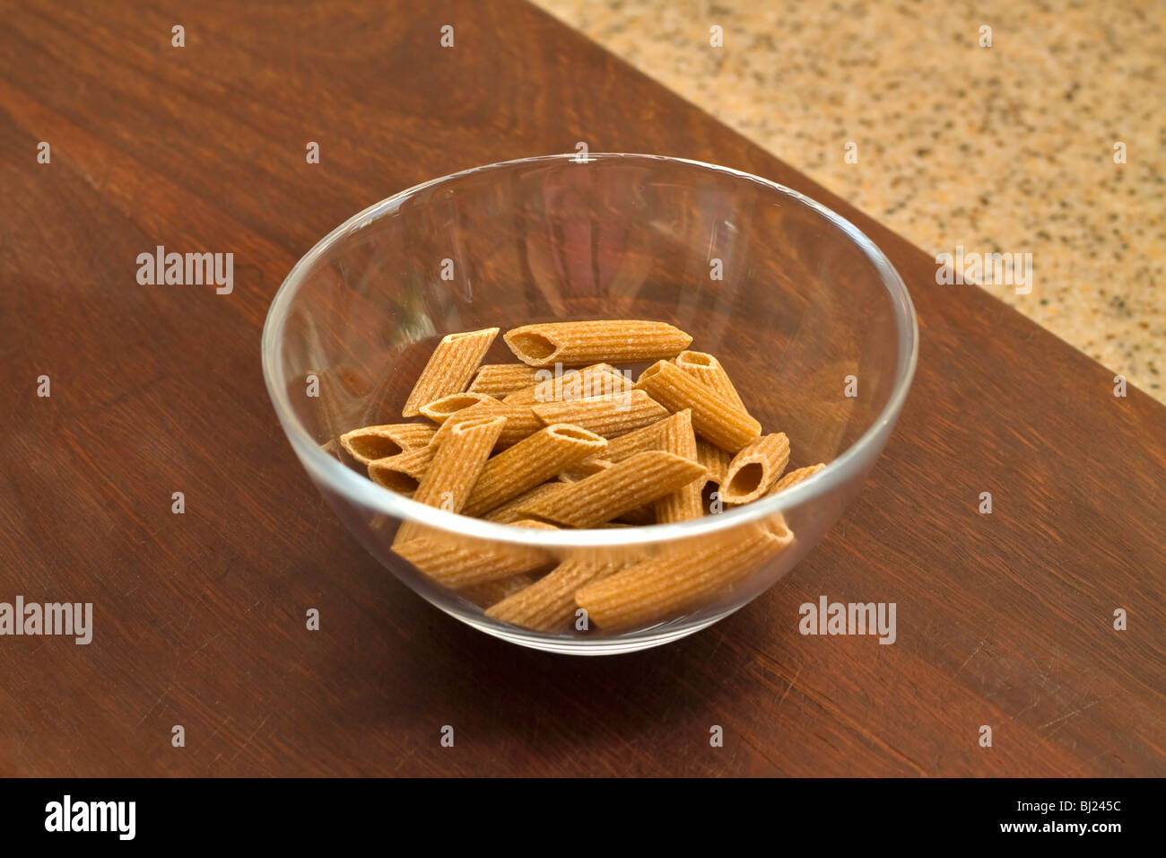 Uncooked wholemeal penne rigata pasta Stock Photo