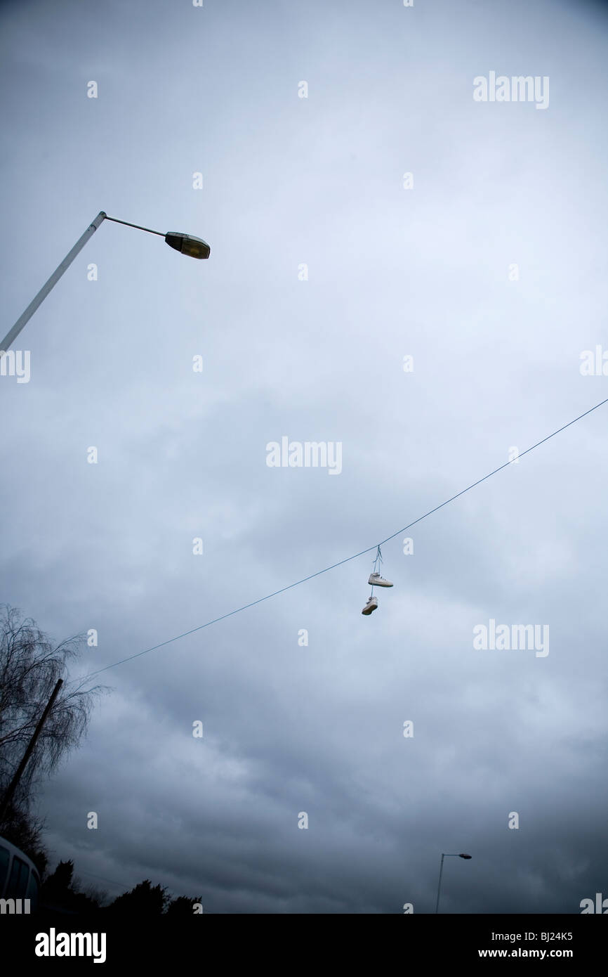 Shoes hanging from telephone line Stock Photo Alamy