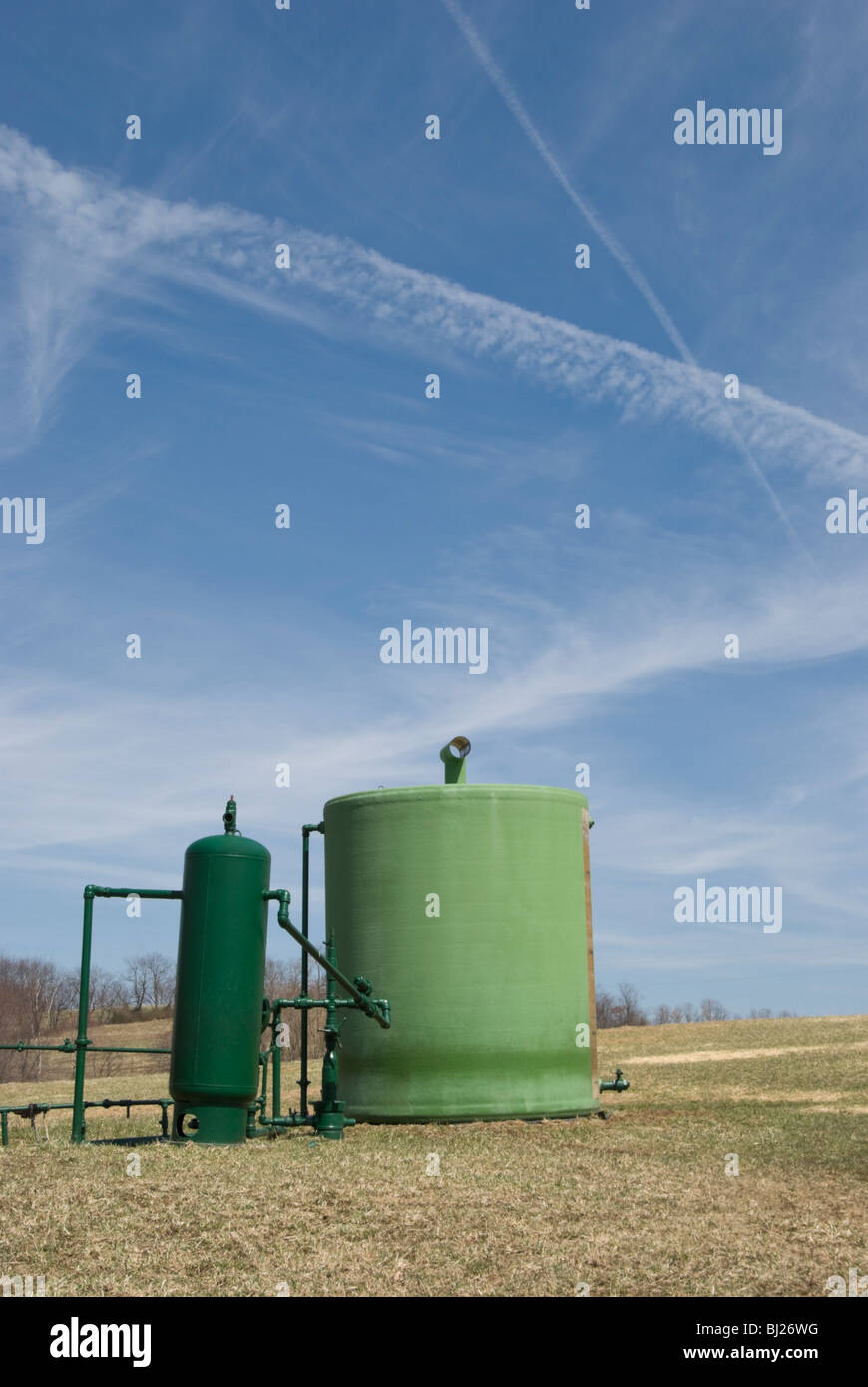 Natural gas well in a spring farm field in rural Pennsylvania, PA, USA. Stock Photo