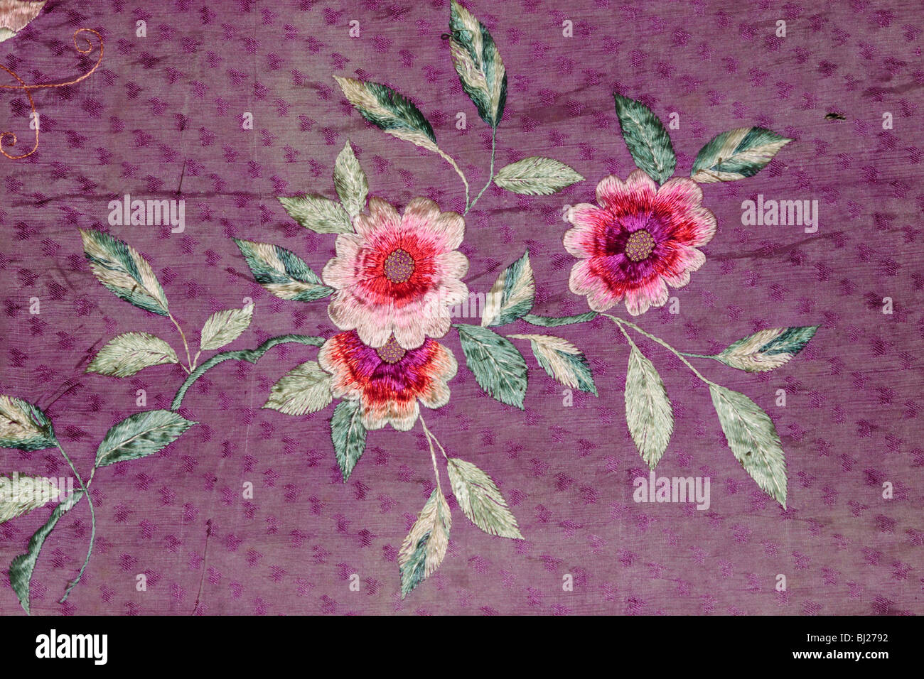 Antique Chinese silk fabric with hand embroidered floral design Stock Photo