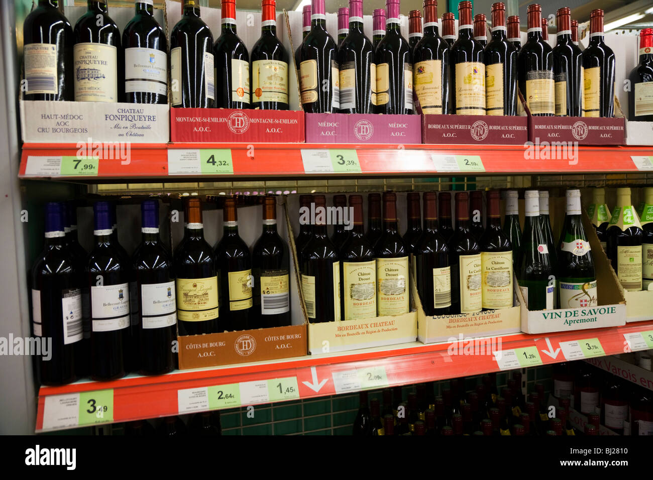 A shelf display of alcohol / alcoholic wine / wines and liquor drink