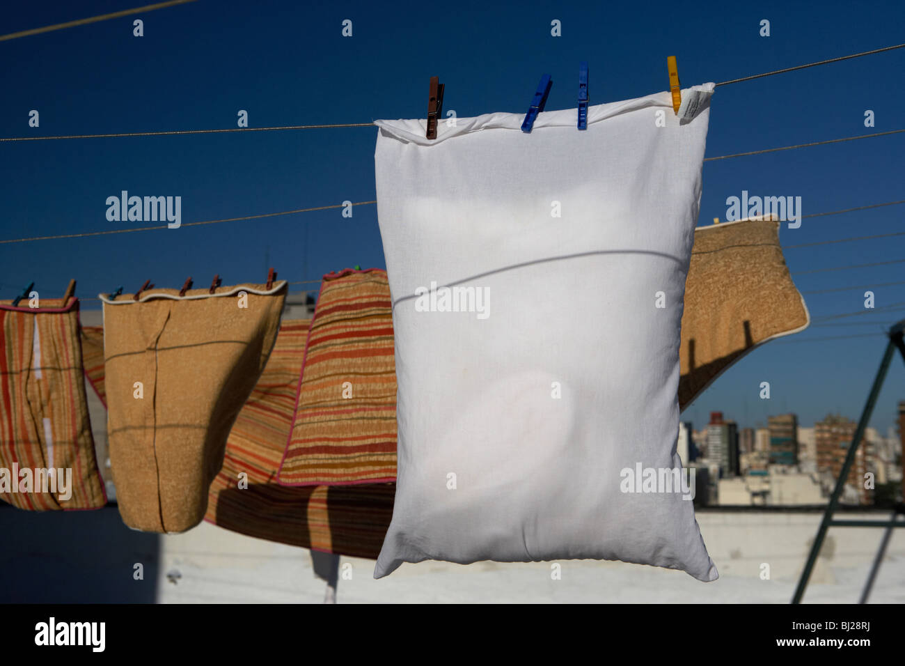 Pillow Hanging On A Washing Line In Front Of Pillow Cases Drying