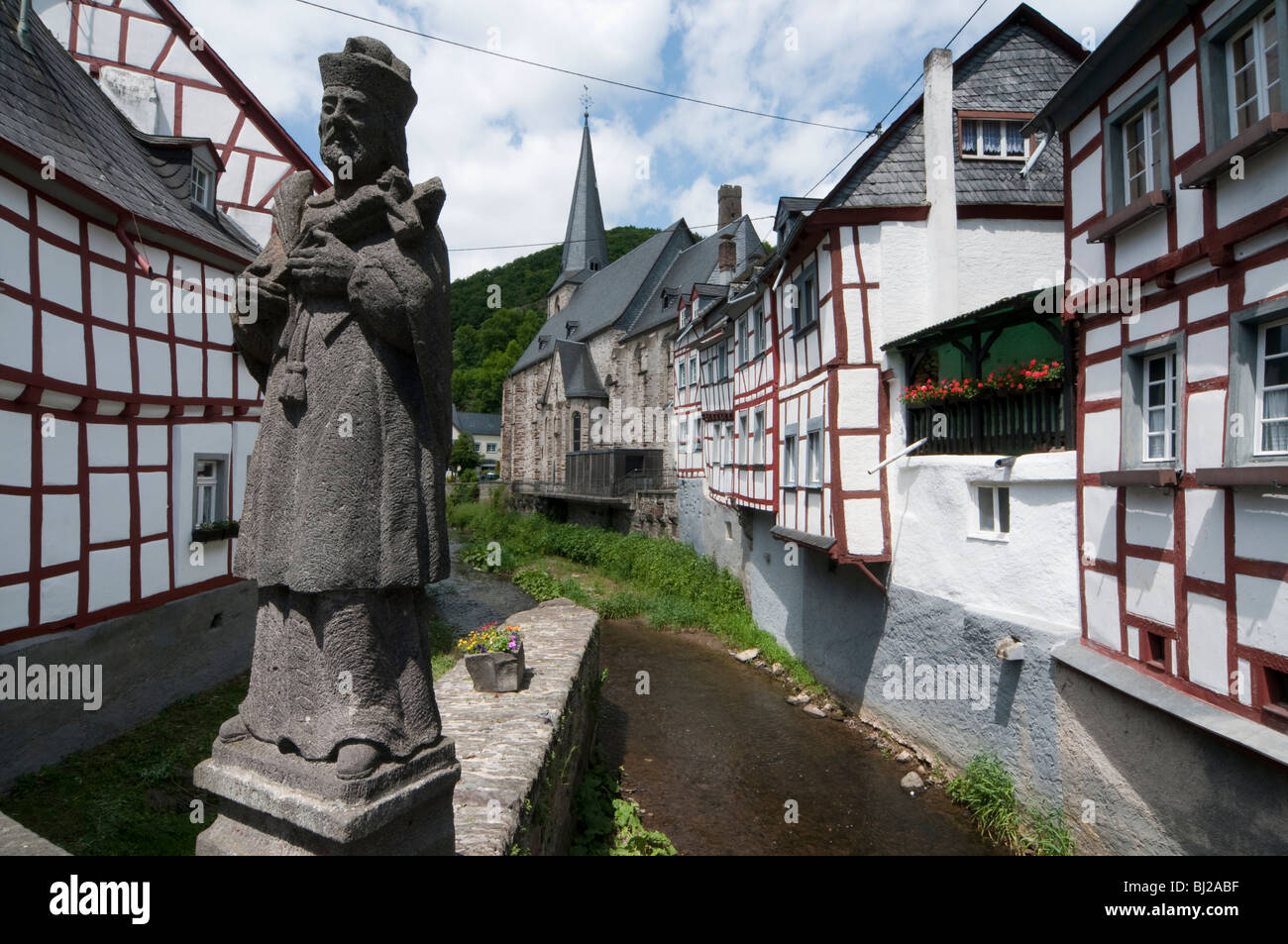 timber framed houses, statue, church, Monreal, Eifel, Rhineland-Palatinate, Germany Stock Photo