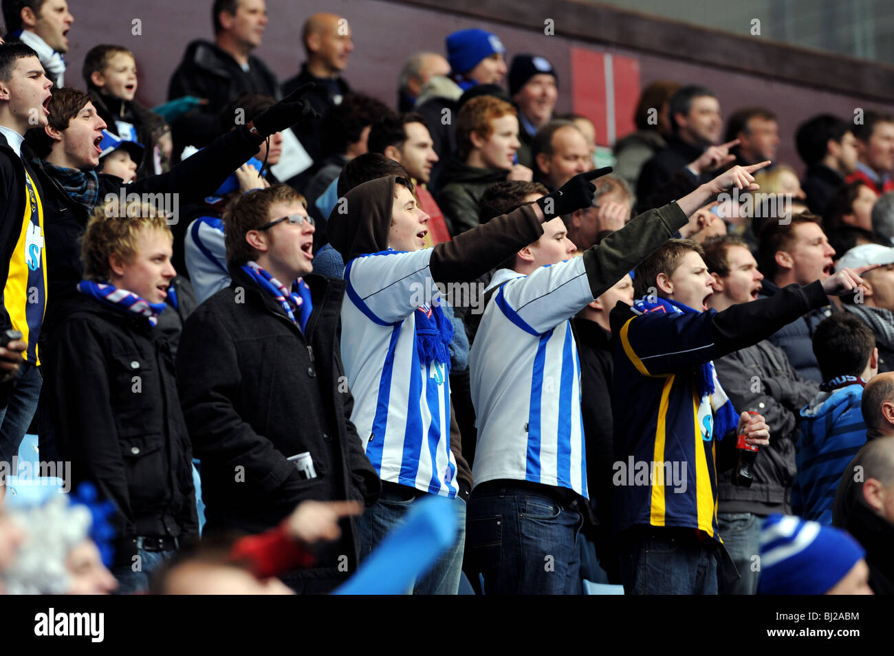 Football fans chanting at at match Stock Photo