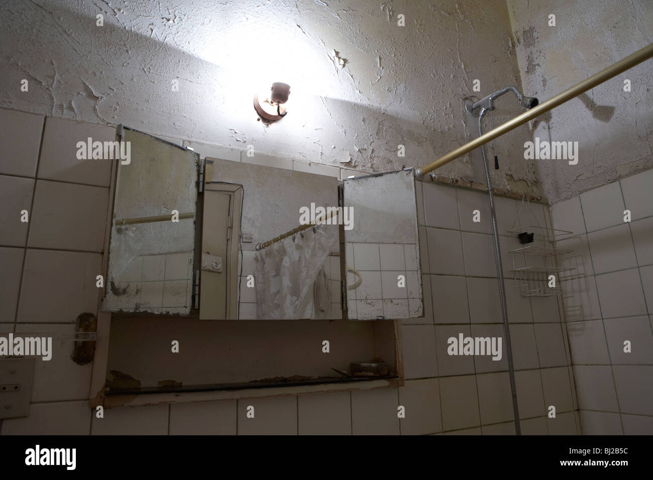 decaying bathroom and shower in a run down bathroom Stock Photo