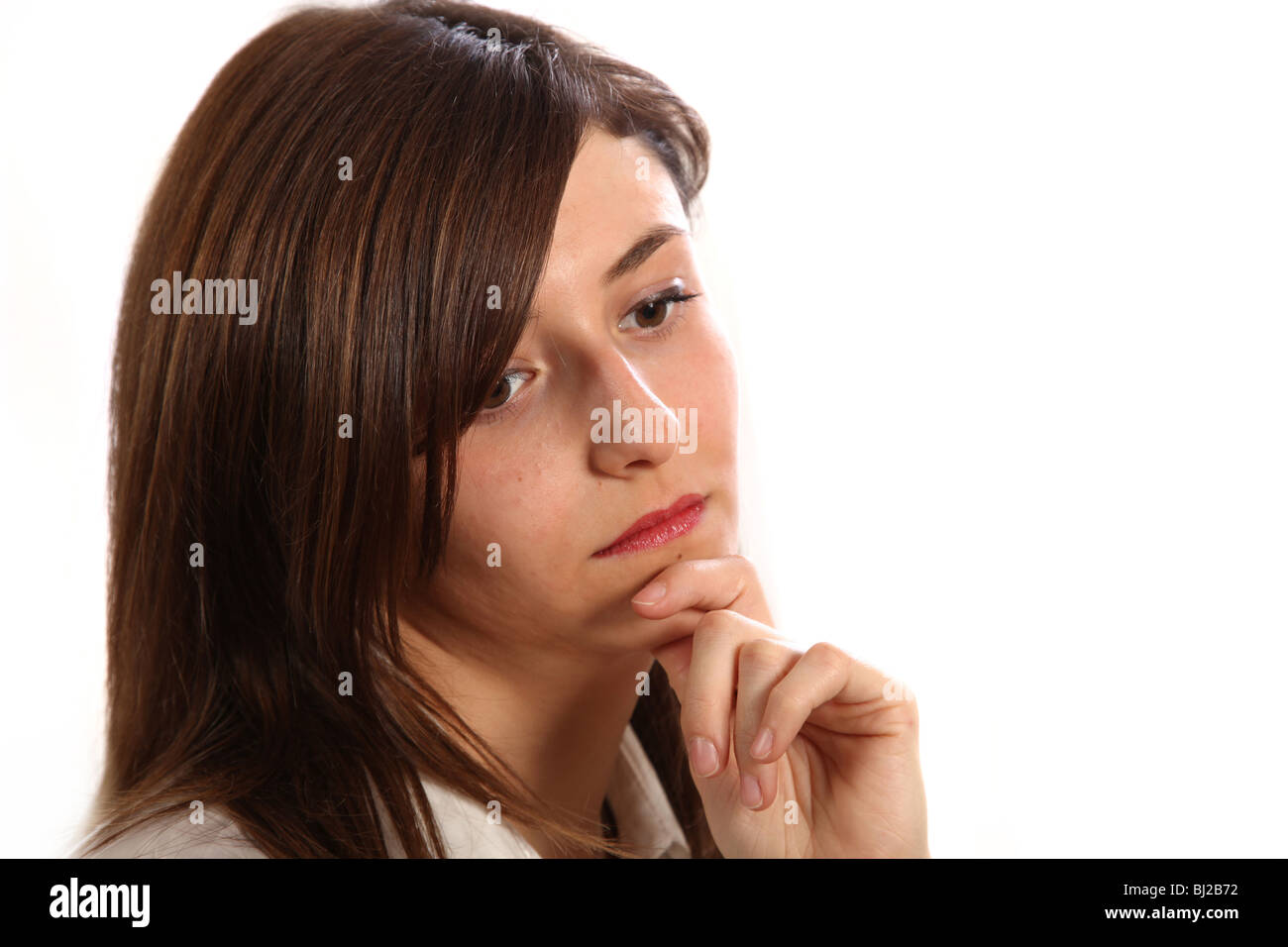 young, sad woman that looks sad and depressed to the floor. Stock Photo