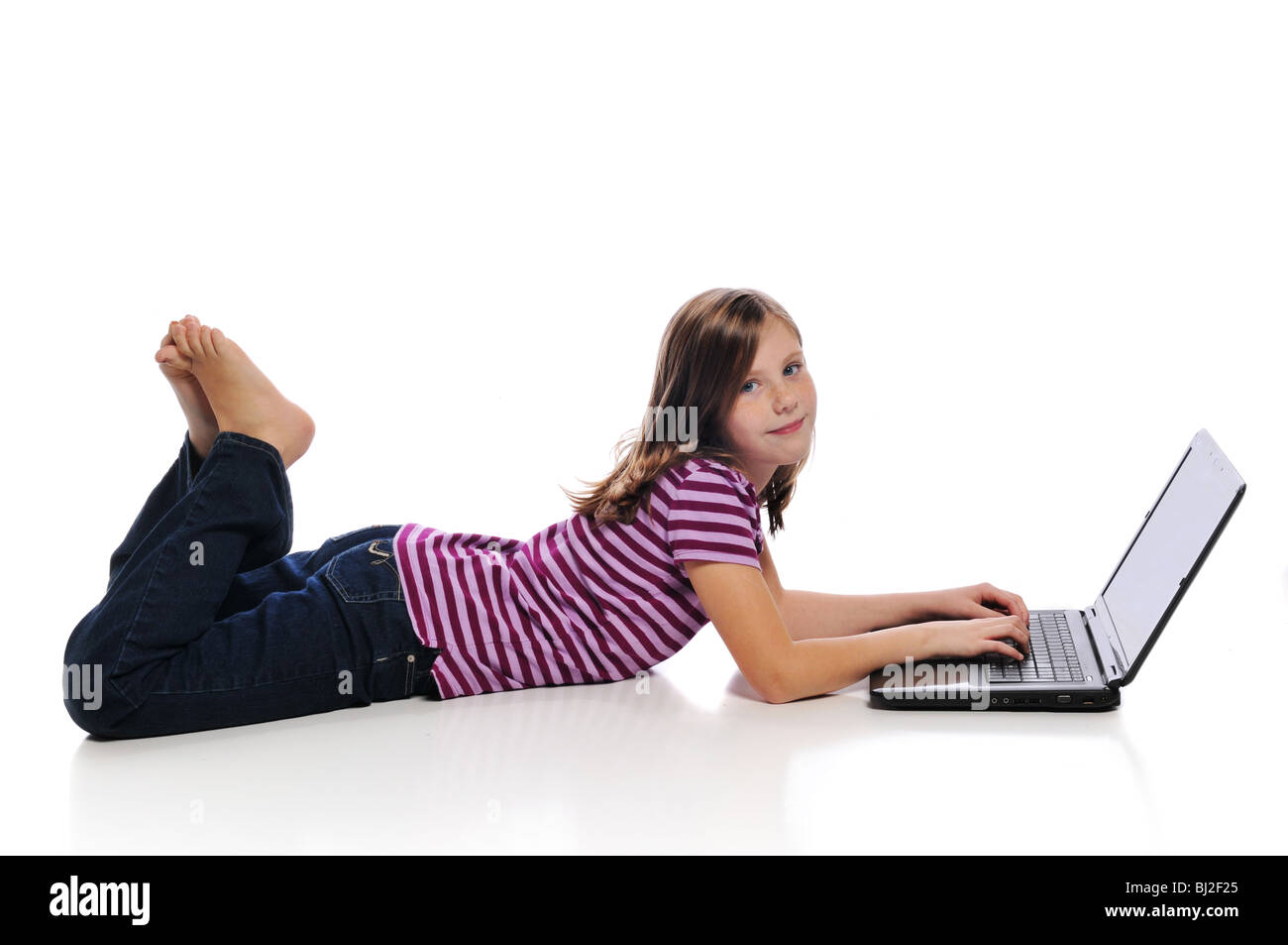 Little girl with a laptop isolated on a white background Stock Photo ...