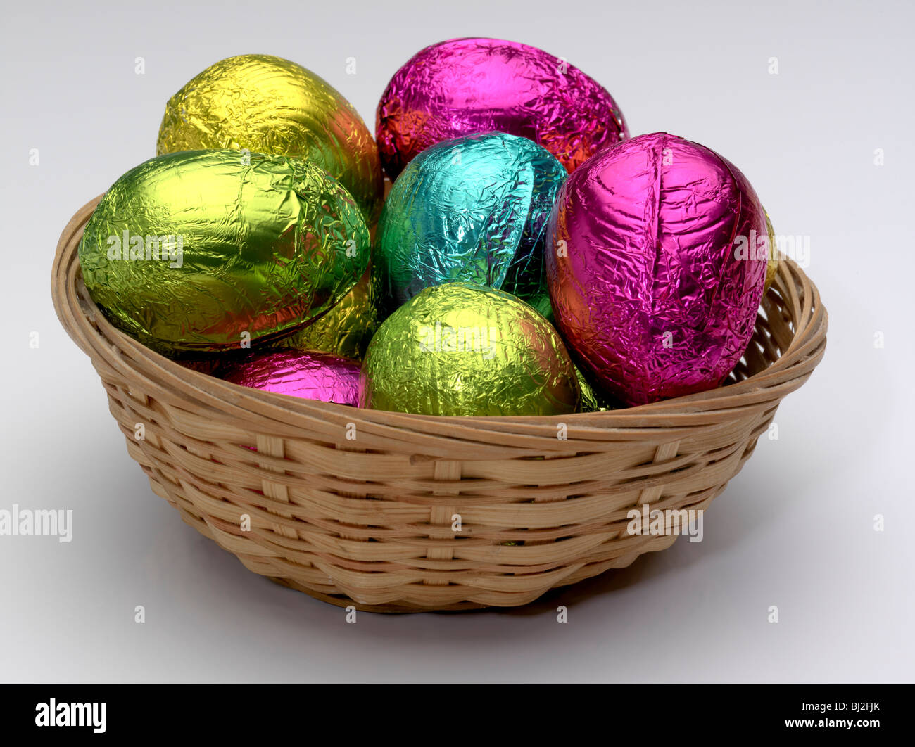 Basket of brightly coloured Easter Eggs. Stock Photo