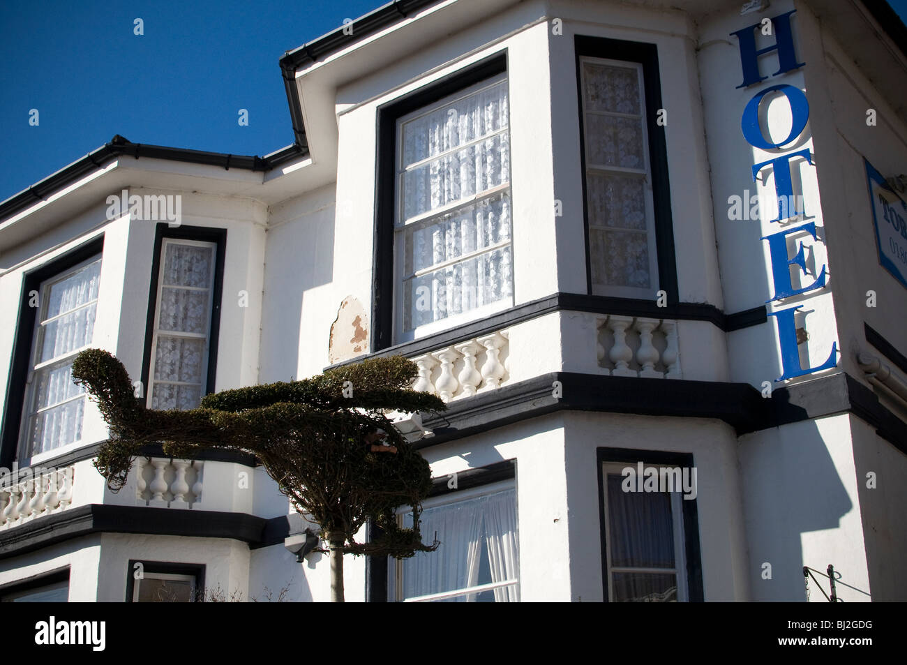 Torquay hotel reminiscent of Fawlty Towers with bush shaped as Helicopter Stock Photo Alamy
