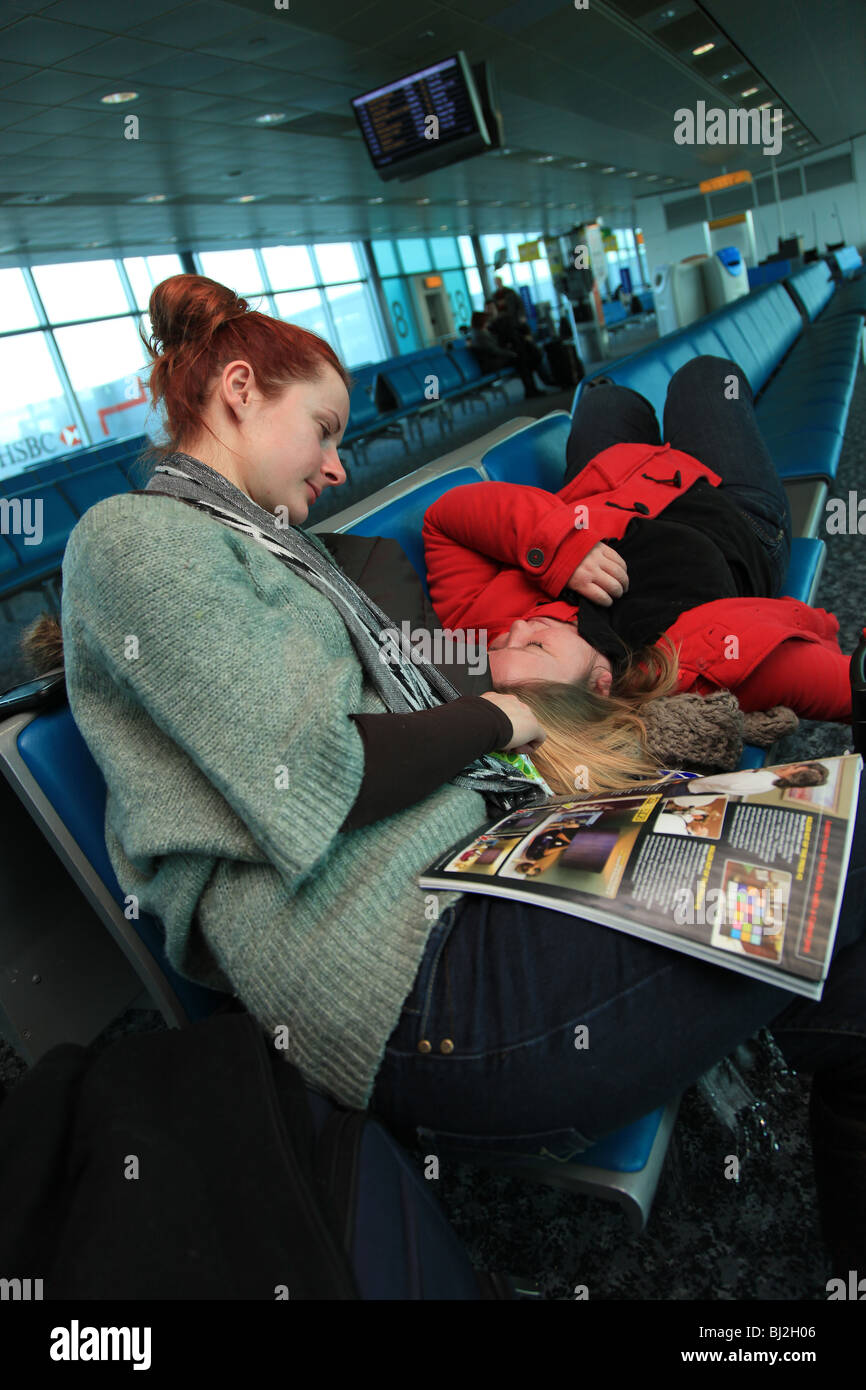 Travelers waiting in an airport lounge, Stansted Airport, UK Stock